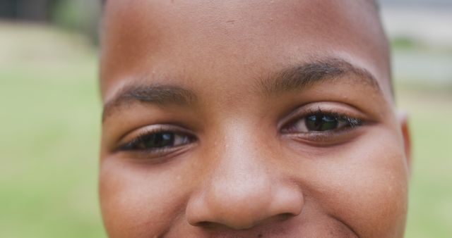Close-up of Smiling Afro-American Boy with Outdoors Background - Download Free Stock Images Pikwizard.com