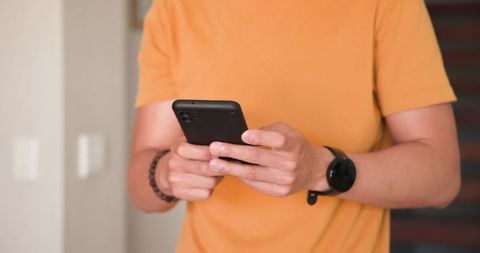 Man Holding Smartphone in Modern Interior