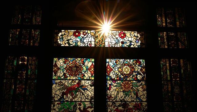 Sunburst Through Ornate Stained Glass in Chapel