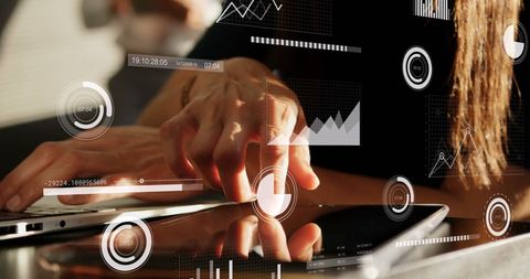 Businesswoman Analyzing Data on Laptop with Interactive Graphics