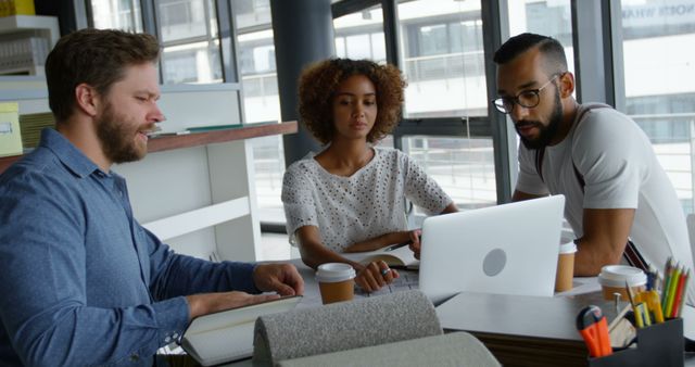 Diverse Team Collaborating in Modern Office Around Laptop - Download Free Stock Images Pikwizard.com