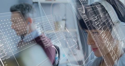 Woman with headset analyzing holographic data in modern office