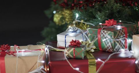 Colorful Wrapped Gifts Under Twinkling Christmas Tree