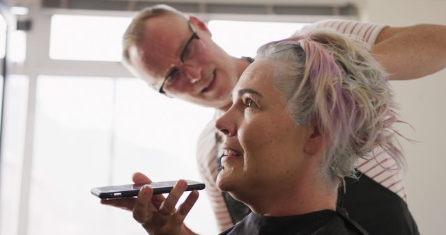 Female Client Getting Hair Styled While Using Mobile Phone in Salon - Download Free Stock Images Pikwizard.com