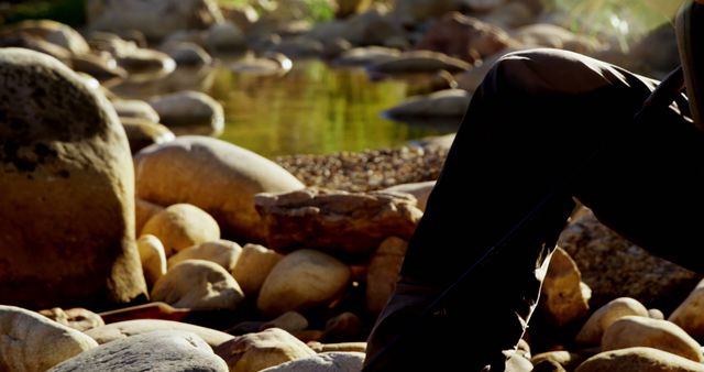 Person Exploring Rocky Stream during Golden Hour - Download Free Stock Images Pikwizard.com