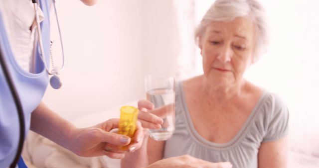 Nurse Assisting Elder Woman with Medication at Home - Download Free Stock Images Pikwizard.com