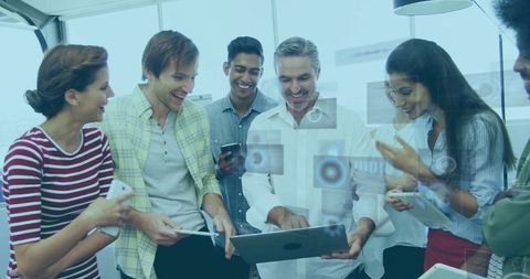 Diverse Team Analyzing Digital Data with Laptops and Smartphones