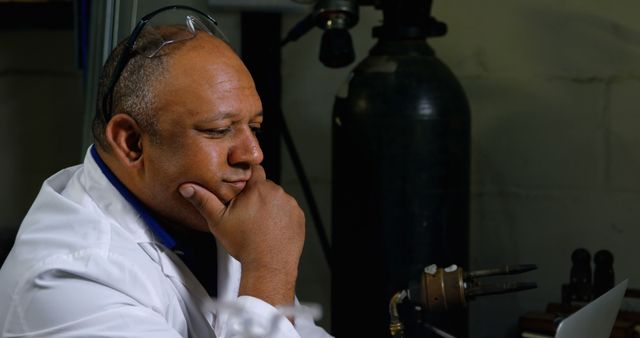 Engineer Contemplating Workstation in Laboratory - Download Free Stock Images Pikwizard.com