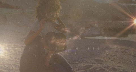 Bohemian woman beach sunset holding hat