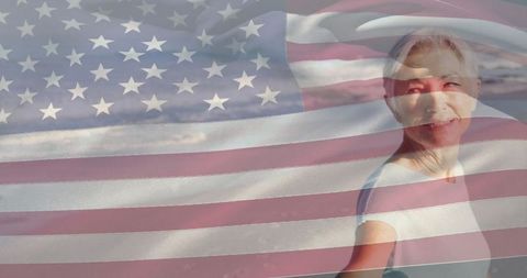 Senior woman in serene coastal scene with american flag overlay