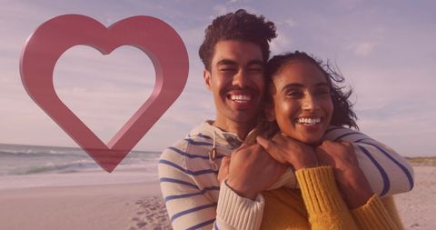 Joyful Couple Hugging on Beach with Heart Motif