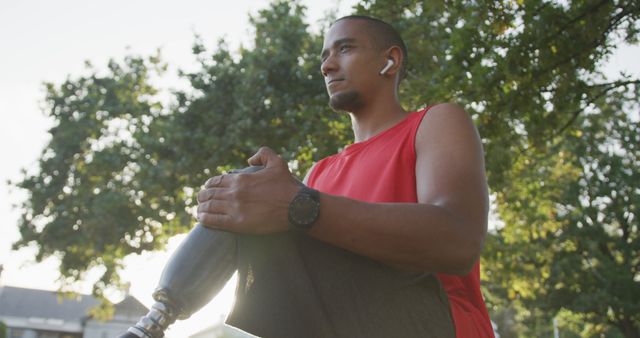 Determined Athletic Man with Prosthetic Leg Stretching in Park - Download Free Stock Images Pikwizard.com