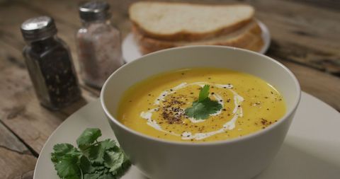 Creamy Carrot Soup with Artisan Bread and Fresh Herbs