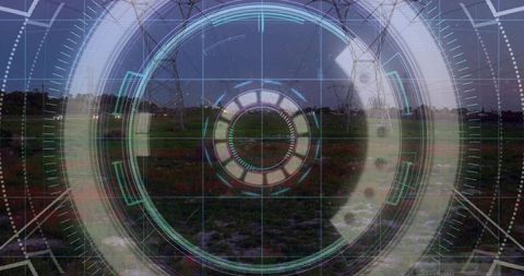 Projecting holographic circular HUD over utility corridor at dusk featuring power pylons