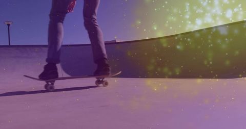 Skateboarder Carving Concrete Bowl at Sunset with Motion Light Particles