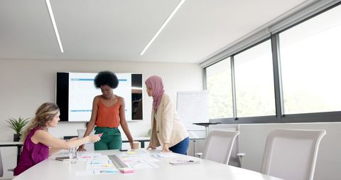 Diverse Female Team Brainstorming Business Ideas in Modern Office