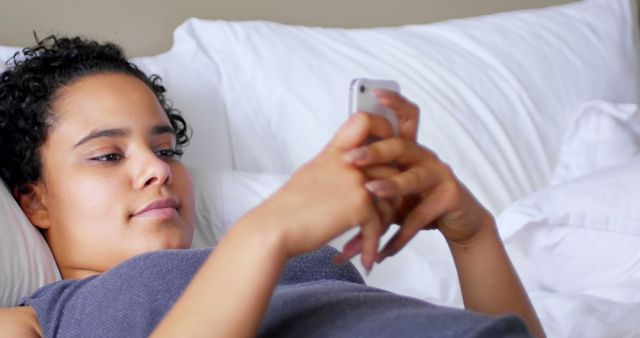 Relaxed Woman Lying in Bed Using Smartphone at Home - Download Free Stock Images Pikwizard.com