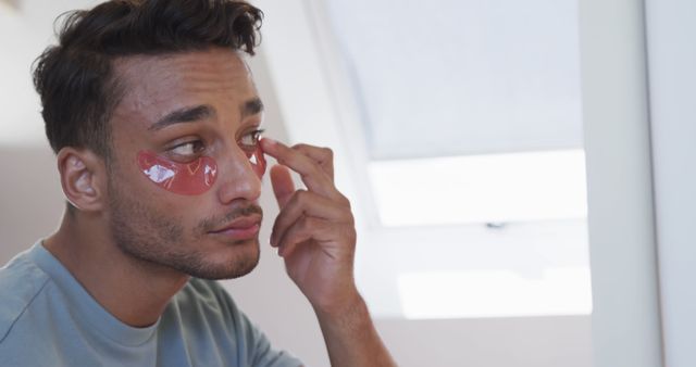 Man Applying Under Eye Masks for Skincare Routine - Download Free Stock Images Pikwizard.com