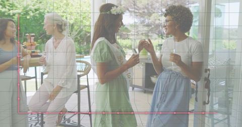 Bridal shower celebrating with champagne, bride-to-be wearing sash and flower crown