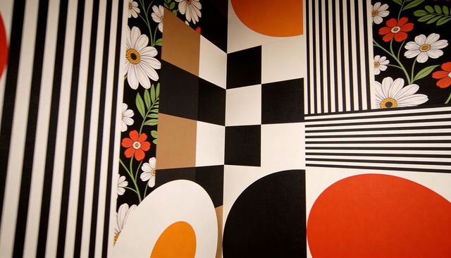 Wrapping corner wall with bold geometric circles, checkerboard and daisy panels
