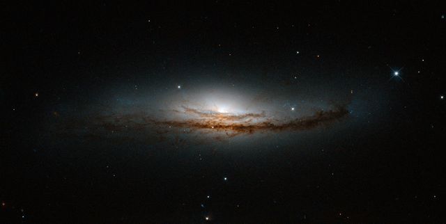 Stunning Spiral Galaxy NGC 5793 with Luminous Center and Dust Lane - Download Free Stock Photos Pikwizard.com