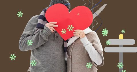 Elderly Couple Behind Heart in Winter Setting
