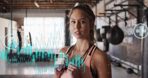 Woman using wearable fitness technology in modern gym