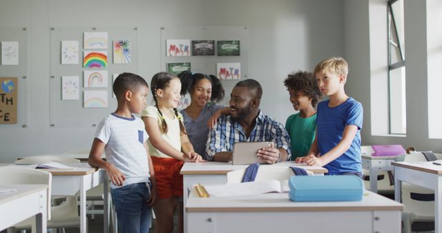 Image of happy african american male teacher and class of diverse pupils working on tablet - Download Free Stock Photos Pikwizard.com