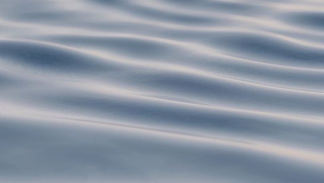 Gliding Silvery-Blue Water Ripples Creating Diagonal Parallel Wavelets for Calm Abstract Background
