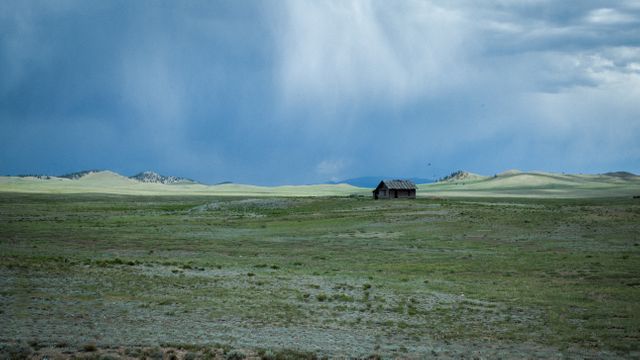 Brown Cabin on the Green Fields Below the Blue Sky - Download Free Stock Photos Pikwizard.com