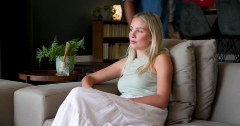Young Woman Relaxing in Contemporary Living Room Contemplating