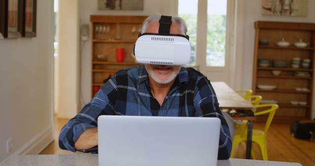 Senior Man Using Virtual Reality Headset and Laptop at Home - Download Free Stock Images Pikwizard.com