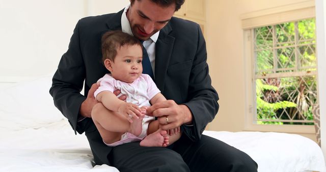 Businessman Holding Baby in Bedroom - Download Free Stock Images Pikwizard.com