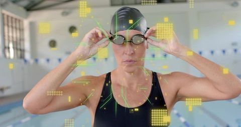 Female swimmer adjusting goggles with augmented reality telemetry overlay indoor pool