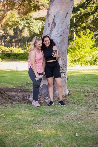 Young Women Taking Selfie in Park Celebrating Friendship