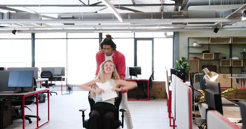 Cheerful colleagues having fun in modern office