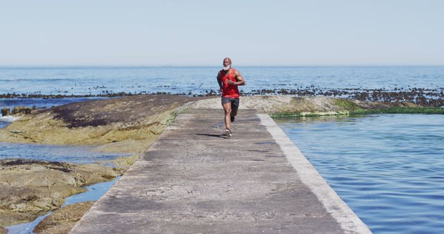Athletic Man Jogging by Coastal Ocean Pathway - Download Free Stock Images Pikwizard.com