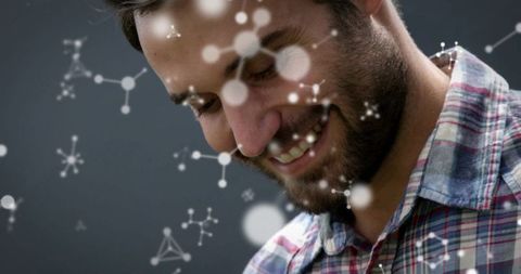 Smiling man with molecular graphics symbolizing science and innovation