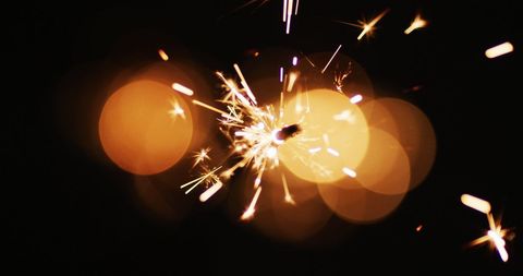 Close-Up of Sparkler with Glowing Sparks Against Black Background - Download Free Stock Images Pikwizard.com