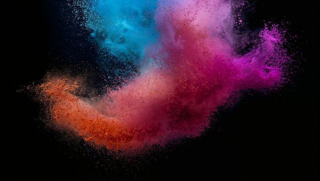 Vibrant colorful powder explosion on black background