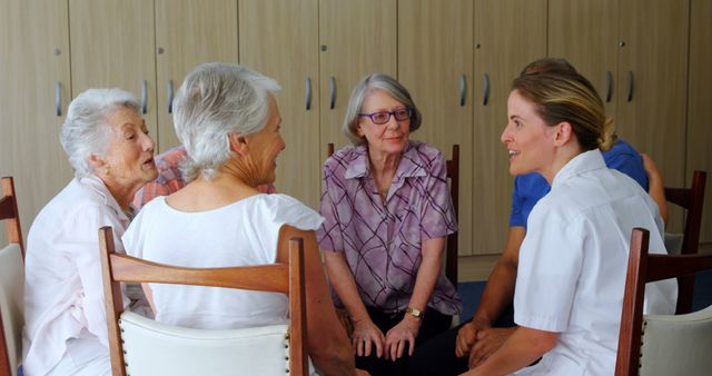 Seniors Engaging in Group Discussion with Caregiver at Nursing Home - Download Free Stock Images Pikwizard.com