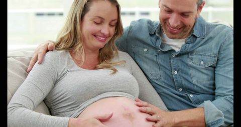 Expectant Couple Enjoying Relaxing Moment on Couch