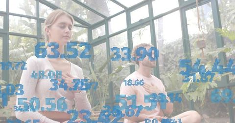 Meditating couple practicing mindfulness in glass greenhouse with blue biometric data overlay
