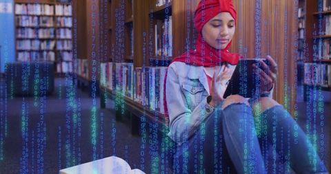 Young Student in Hijab Engaging with Digital Data on Tablet