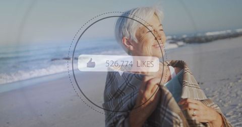 Joyful Senior Woman at Beach Embracing Digital Connectivity