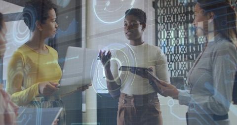 Tech-savvy women using holographic display in smart office