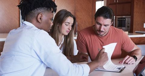 Diverse friends collaborating on creative project at table