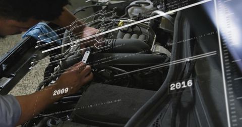 Mechanic diagnosing engine with digital data overlay and timeline 2009-2016