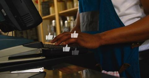 Cashier typing on pos register with thumbs-up overlays showing customer feedback at checkout