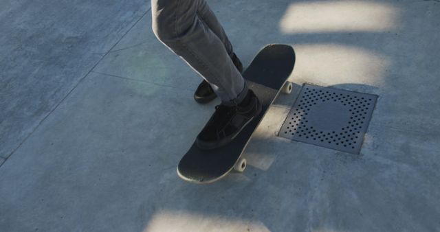 Low section of caucasian man skateboarding at a skatepark. hanging out at skatepark in summer.